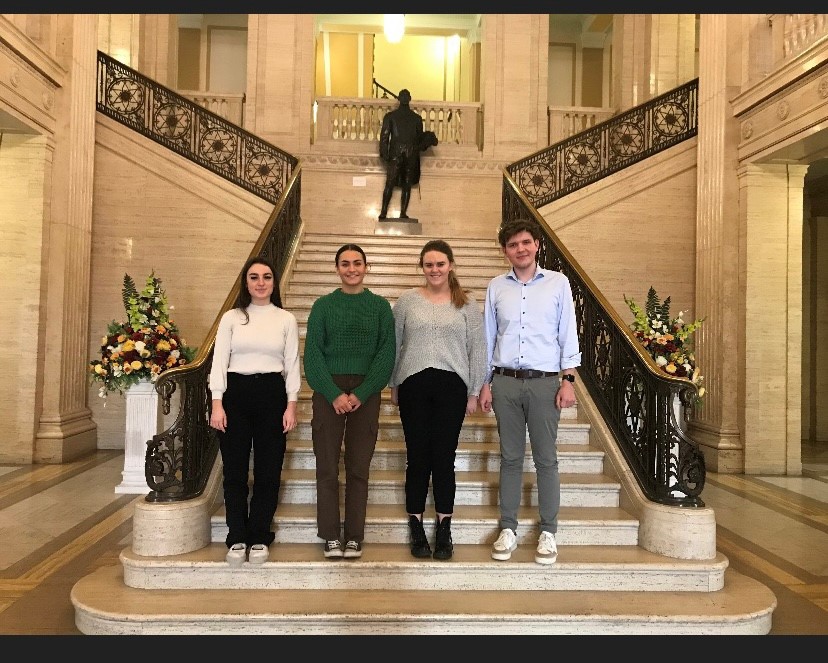 Stranmillis students Anna, Claire, Rachel and Paul standing on the the staircase in the Great Hall, Parliament Buildings.
