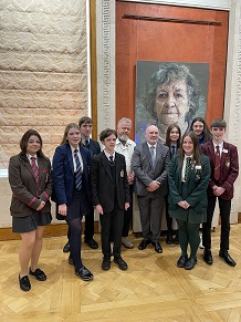 Young people from different school sectors along with artist Colin Davidson and the Speaker Alex Maskey, viewing the Silent Testimony portraits to mark the Belfast/Good Friday Agreement in April 2023 